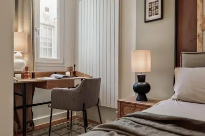 a dining room table with chairs and a vase on it at Karakoy - 2 bedrooms and balcony in Eixample Dreta in Barcelona