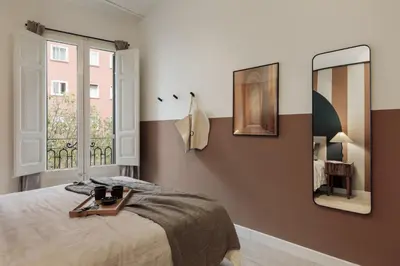 a bedroom with a bed with a mirror on the wall at Sinan - 2 bedrooms and balcony in Sant Gervasi in Barcelona