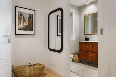 a wooden cabinet with two vases and a picture on it at Jaen - 2 bedrooms and office in Sant Gervasi in Barcelona