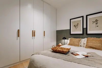 a bedroom with a large bed with white cabinets at Jaen - 2 bedrooms and office in Sant Gervasi in Barcelona