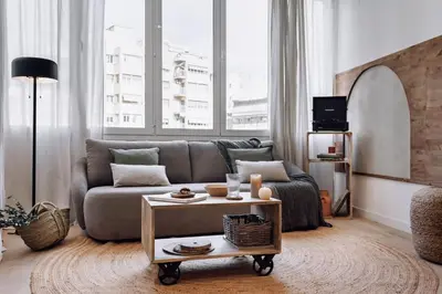a living room with a couch and a table at Genave - 2 bedrooms in Eixample Esquerra in Barcelona