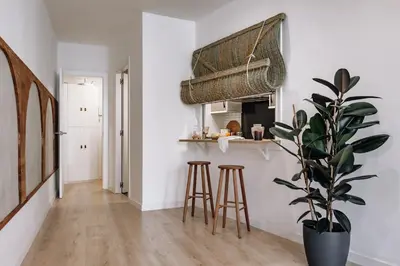 a living room with a couch and a large mirror at Genave - 2 bedrooms in Eixample Esquerra in Barcelona