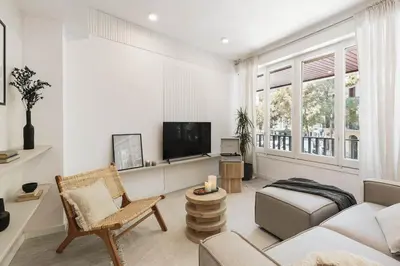 a living room with a couch and a tv at Palinuro - 3 bedrooms in Sant Antoni in Barcelona