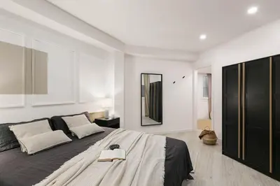 a bedroom with a bed and a desk with a chair at Palinuro - 3 bedrooms in Sant Antoni in Barcelona