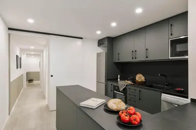 a living room with a couch and a tv at Palinuro - 3 bedrooms in Sant Antoni in Barcelona