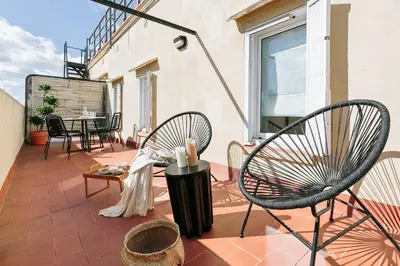 a kitchen and living room with a table and chairs at Soffio - Studio and terrace in Gràcia in Barcelona