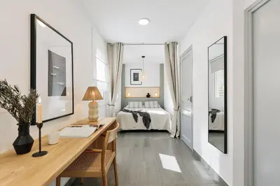 a kitchen with white cabinets and a counter top at Soffio - Studio and terrace in Gràcia in Barcelona