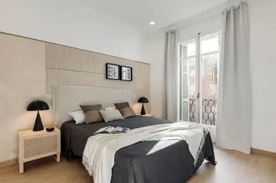 a bedroom with a bed and a glass door at Costa - 3 bedrooms, balcony in Eixample Esquerra in Barcelona
