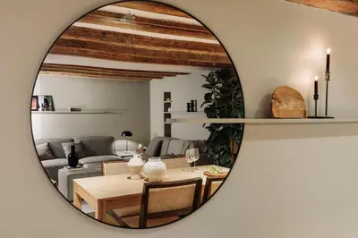 a bedroom with a large bed and a brick wall at Vila - 3 bedrooms and office in El Born in Barcelona