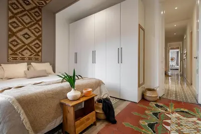 a dining room with a wooden table and chairs at Natuna - 3 bedrooms in Eixample Esquerra in Barcelona