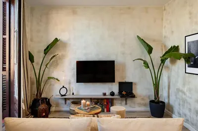 a living room with a white couch and a tv at Natuna - 3 bedrooms in Eixample Esquerra in Barcelona