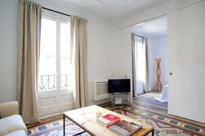 a living room with a couch and a table and a tv at BarcelonaForRent The Claris Suites II in Barcelona