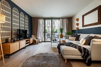 a living room with a couch and a tv at Nema - 3 bedrooms balcony in Eixample Esquerra in Barcelona