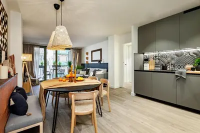 a living room with a tv and a wall with arches at Nema - 3 bedrooms balcony in Eixample Esquerra in Barcelona
