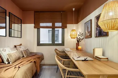 a dining room with a table and chairs and a desk at Nema - 3 bedrooms balcony in Eixample Esquerra in Barcelona