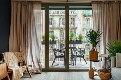 a living room with a couch and a tv at Nema - 3 bedrooms balcony in Eixample Esquerra in Barcelona