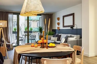 a living room with a couch and a table at Nema - 3 bedrooms balcony in Eixample Esquerra in Barcelona