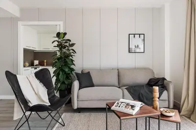 a dining room and living room with a table and chairs at Cervantes - 1 bedroom and pool in Les Corts in Barcelona