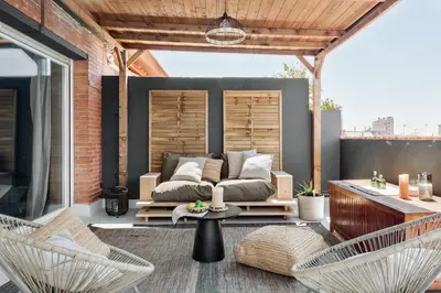 a patio with a couch and chairs and a table at Aura - 3 bedrooms and terrace in Sant Gervasi in Barcelona