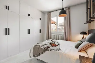 a bedroom with white cabinets and a mirror at Aura - 3 bedrooms and terrace in Sant Gervasi in Barcelona