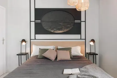 a bedroom with a large bed and a table at Aura - 3 bedrooms and terrace in Sant Gervasi in Barcelona