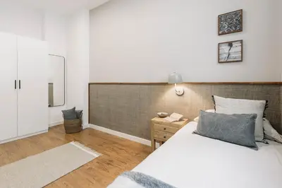 a living room with a white couch and a tv at Velino - 4 bedrooms and office in Sant Antoni in Barcelona