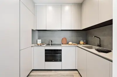 a bedroom with white walls and a bed and a closet at Fiore - 2 bedrooms in Ciutat Vella in Barcelona