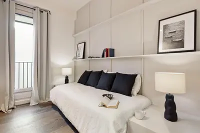 a bedroom with a bed with a book on it at Fiore - 2 bedrooms in Ciutat Vella in Barcelona