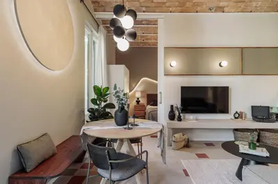 a living room with a table and a couch at Yaki - 2 bedrooms and balcony in Eixample Dreta in Barcelona