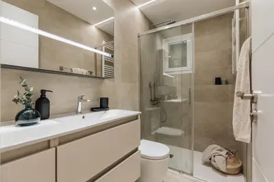 a bedroom with a bed with a table and a mirror at Malena - 3 bedrooms and terrace in Eixample Esquerra in Barcelona