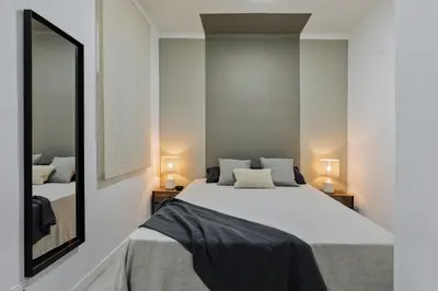 a hallway with a bench and a wall with birds on it at Noguera - 2 bedrooms in Eixample Esquerra in Barcelona