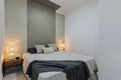 a bedroom with a large bed and a mirror at Noguera - 2 bedrooms in Eixample Esquerra in Barcelona