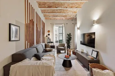 a living room with a couch and a table at Paleo - 2 bedrooms and office in Eixample Dreta in Barcelona