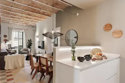 a living room with a couch and a table at Paleo - 2 bedrooms and office in Eixample Dreta in Barcelona