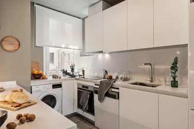 a white bathroom with a sink and a toilet at Paleo - 2 bedrooms and office in Eixample Dreta in Barcelona