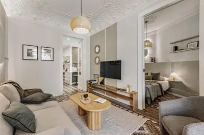 a living room with a couch and a table at Toliman - 1 bedroom and office in Eixample Dreta in Barcelona
