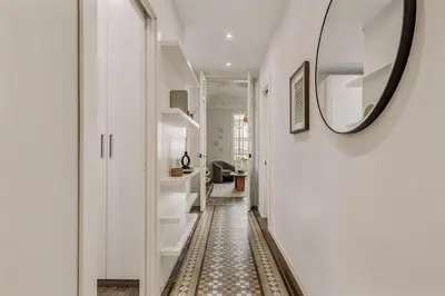 a living room with a chair and a table at Toliman - 1 bedroom and office in Eixample Dreta in Barcelona