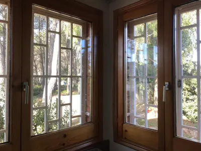 a trio of windows in a room with trees at Can Bosquet - Casa de invitados adosada a casa familiar in Corbera de Llobregat