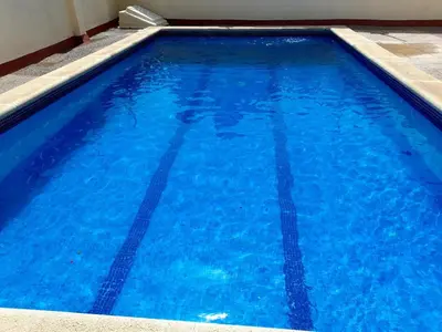 a large blue swimming pool with blue water at Canet playa in Canet de Mar