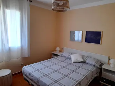 a small bedroom with a bed and a window at Canet playa in Canet de Mar