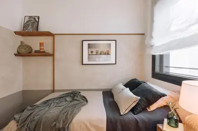a desk with a computer and a lamp on it at Atalaya - 2 bedrooms in Eixample Esquerra in Barcelona