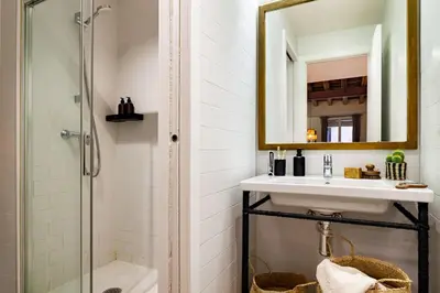 a bedroom with a bed and a table with a lamp at Faya - 1 bedroom and balcony in Gràcia in Barcelona