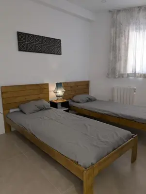 two twin beds in a room with a window at Cal Ticó, 6 guests Monistrol de Montserrat in Monistrol