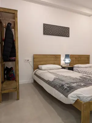 a bedroom with two beds and a shelf at Cal Ticó, 6 guests Monistrol de Montserrat in Monistrol