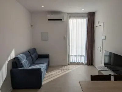 a living room with a couch and a television at Cal Ticó, 6 guests Monistrol de Montserrat in Monistrol