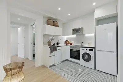 a living room with a tv and a table and chairs at Piano - 2 bedrooms and terrace in Ciutat Vella in Barcelona