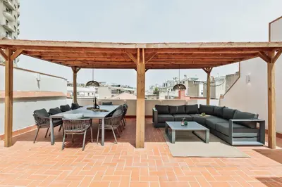 two chairs sitting next to a table with a vase at Piano - 2 bedrooms and terrace in Ciutat Vella in Barcelona