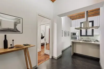 a white bedroom with a bed and a window at Priorat - 4 bedrooms and office in Sant Gervasi in Barcelona
