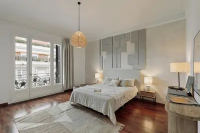 a dining room with a table and chairs and windows at Priorat - 4 bedrooms and office in Sant Gervasi in Barcelona