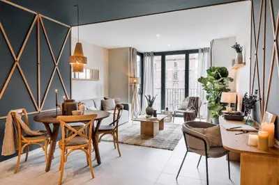 a small bedroom with a bed and a desk at Vacar - 3 bedrooms in Eixample Esquerra in Barcelona